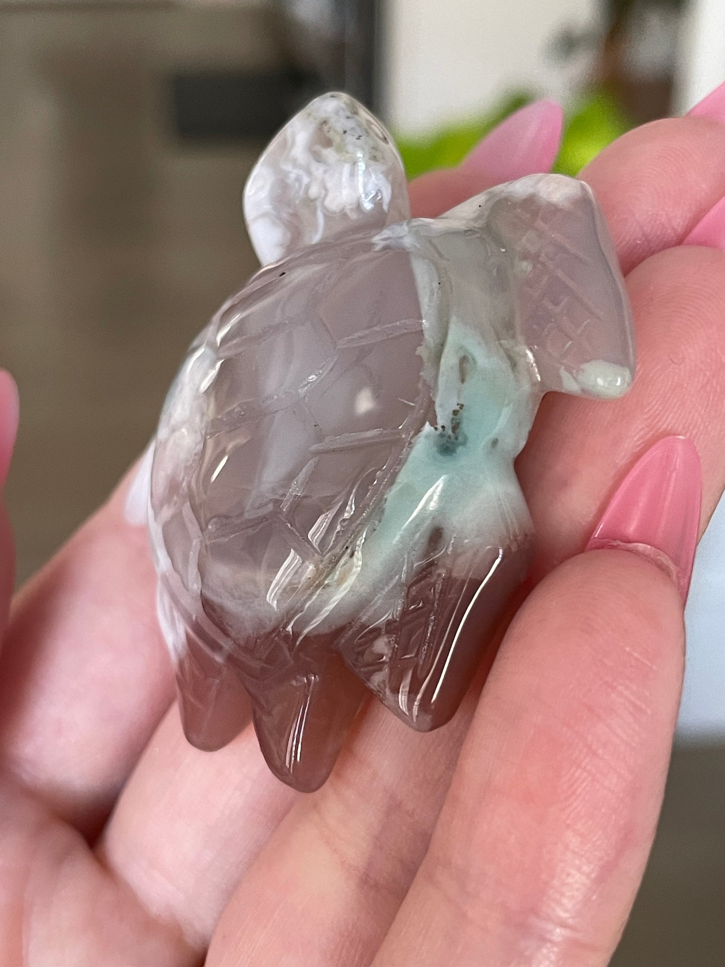 Hand-carved agate turtle figurine with natural green and white floral patterns.