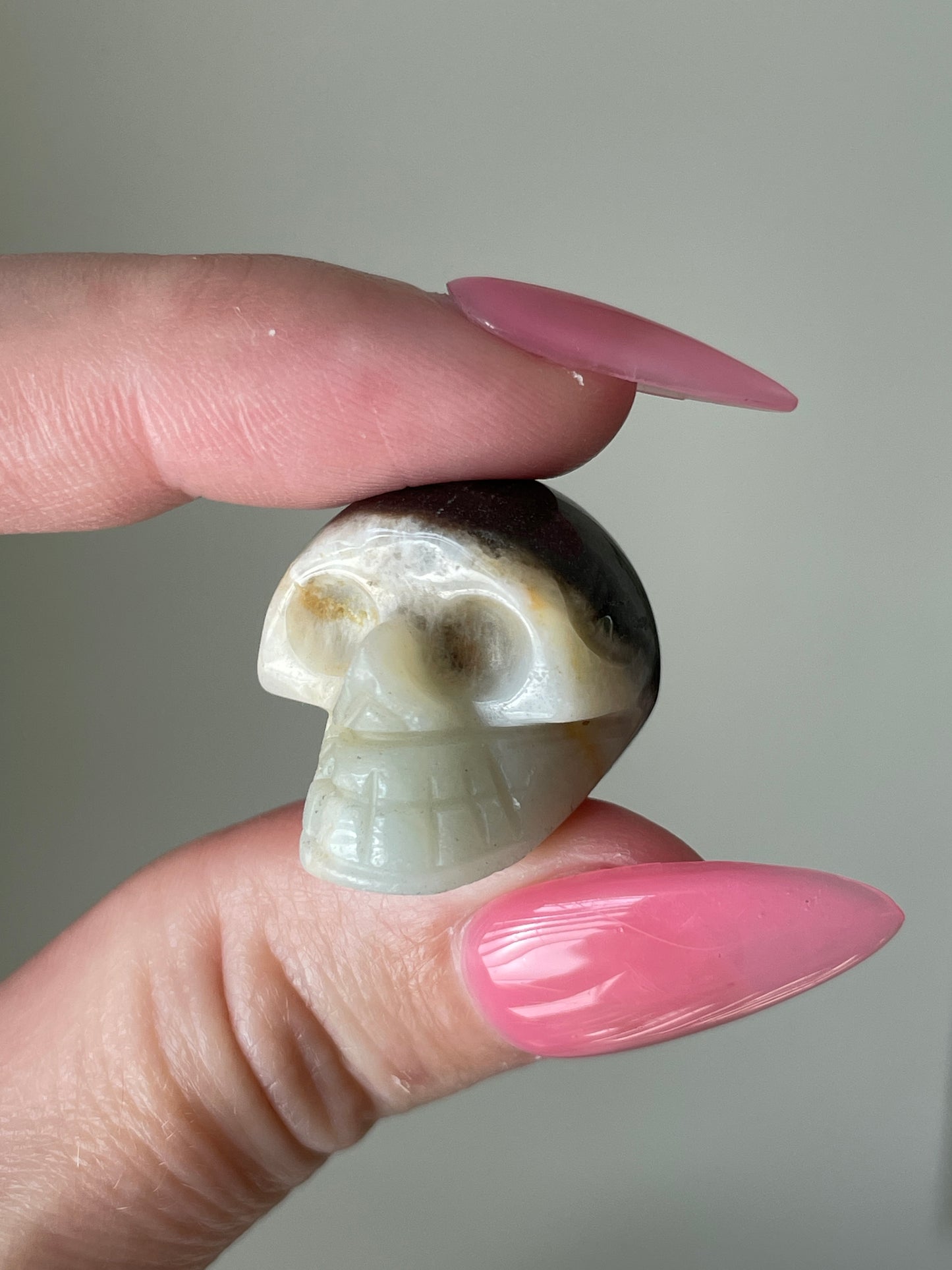 Mini crystal skull, druzy calcite gemstone carving with earthy tones.