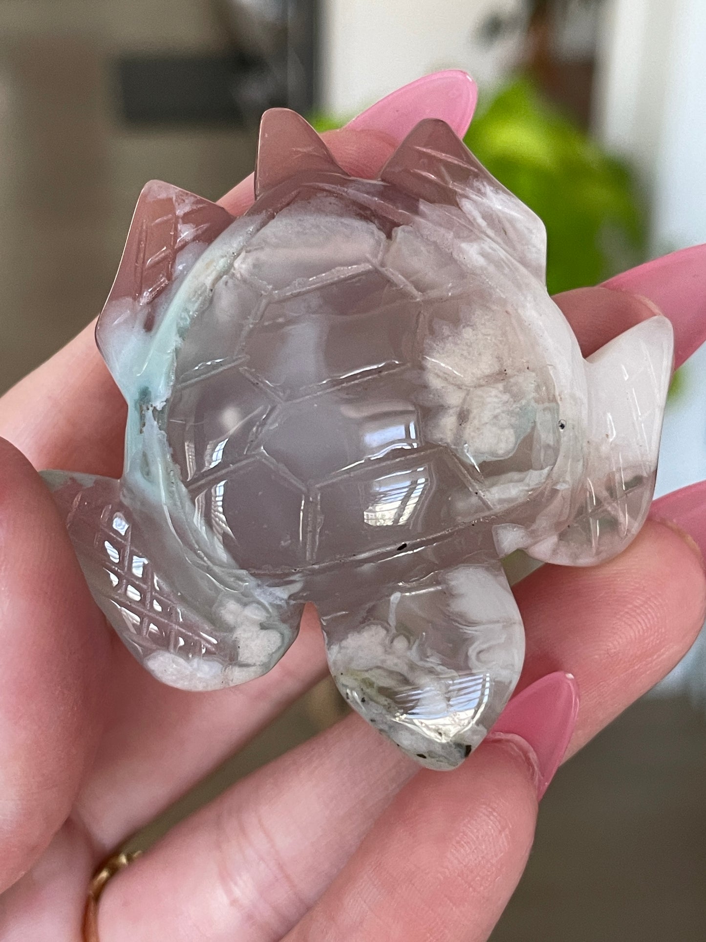 Healing crystal sea turtle made of green flower agate, symbolizing growth and harmony.