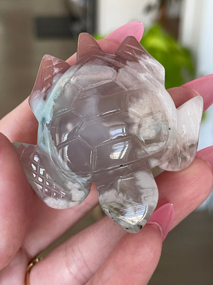 Healing crystal sea turtle made of green flower agate, symbolizing growth and harmony.