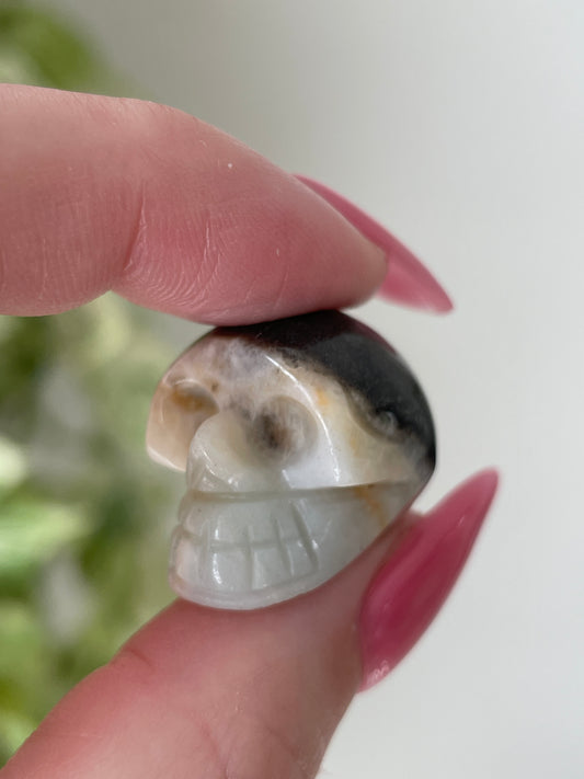 White and brown druzy calcite skull crystal carving, 1-inch gemstone figurine.