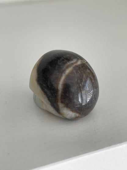 Mini crystal skull, druzy calcite gemstone carving with earthy tones.