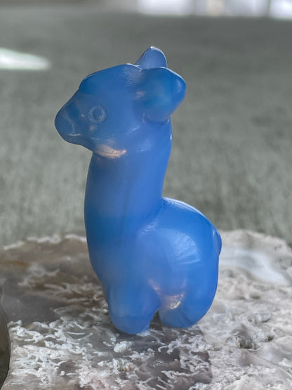 iridescent opalite llama carving, glowing gemstone animal for luck and positivity